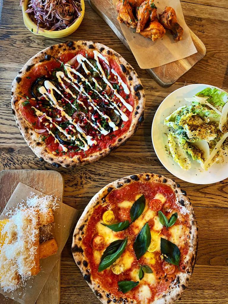 Pizzas and side dishes, polenta fries and salad