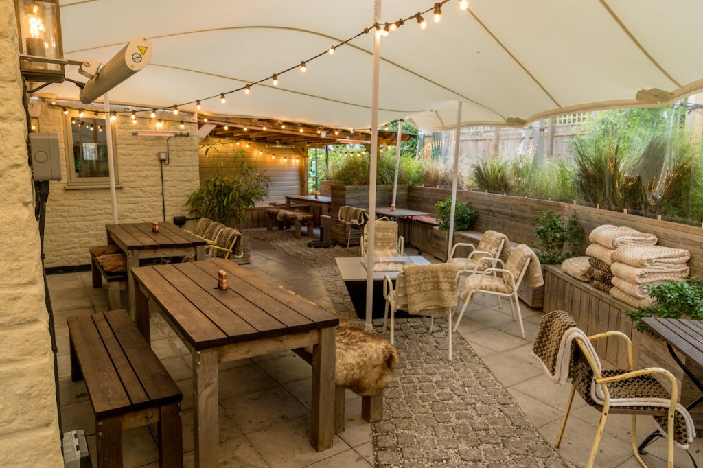 Covered beer garden with wooden seating