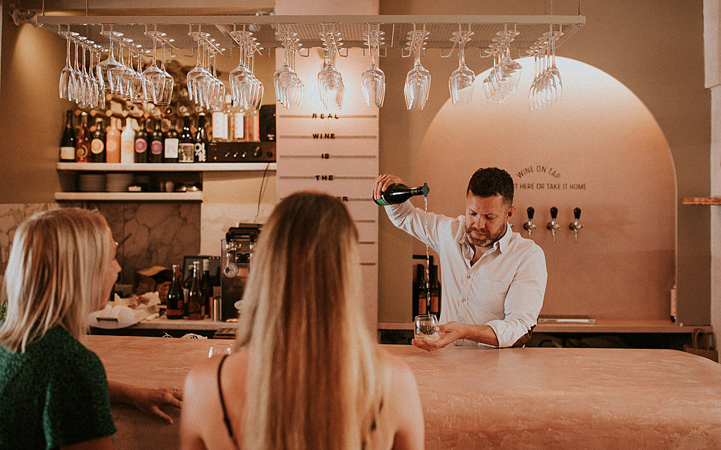 Man pouring wine at bar