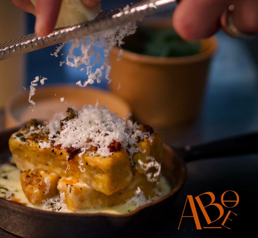 Grating parmesan over food at ABOE