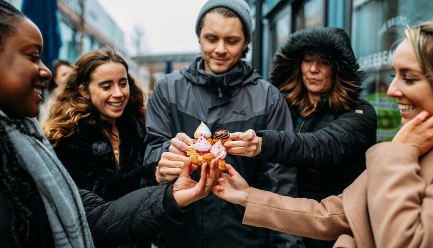Group of people holding desserts