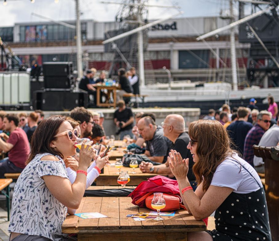 People sat outside drinking beers