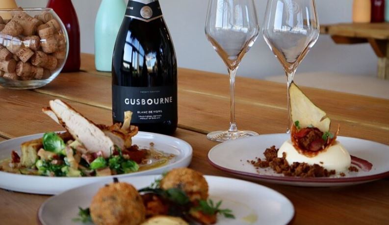 Plates of food and bottle of wine