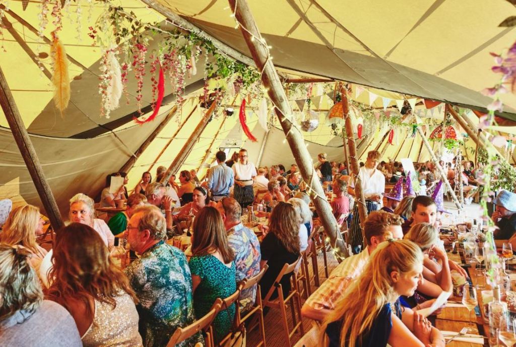 People sat at long tables at Valley Fest