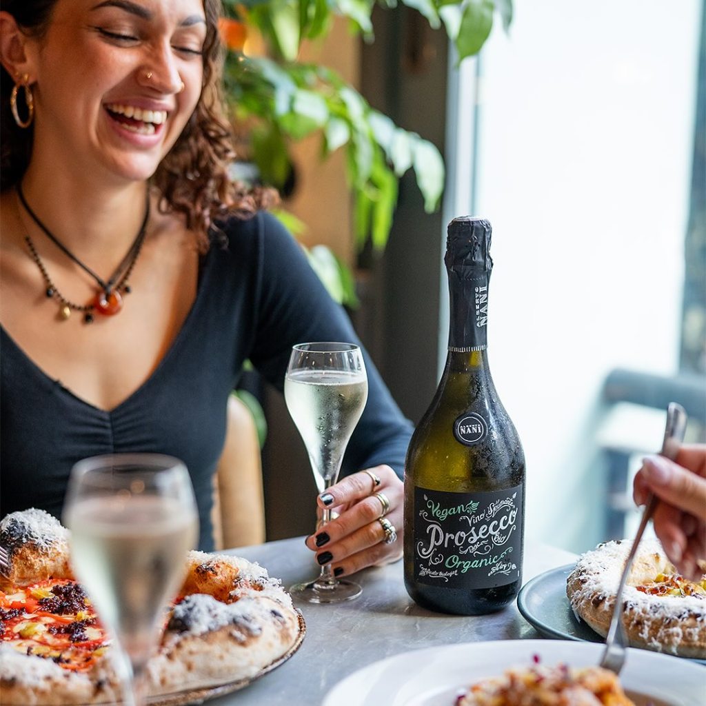 Person with pizza and prosecco