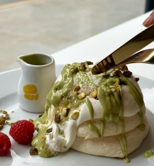 Person cutting into souffle pancakes