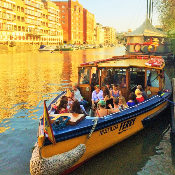 People sat on Bristol Ferry at dusk