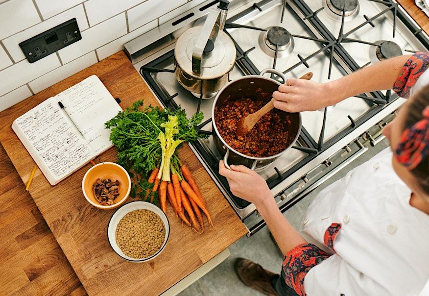 Woman cooking lentil dish in pan