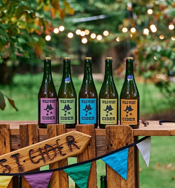 Bottles of cider on fence