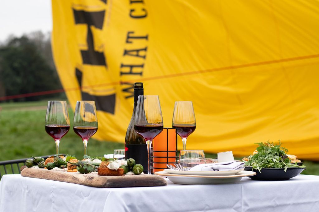 Glasses of wine and snacks on table outdoors