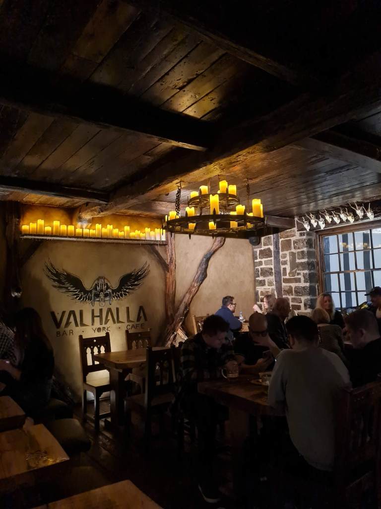 Inside dark and cosy pub with candlelight and exposed wooden beams