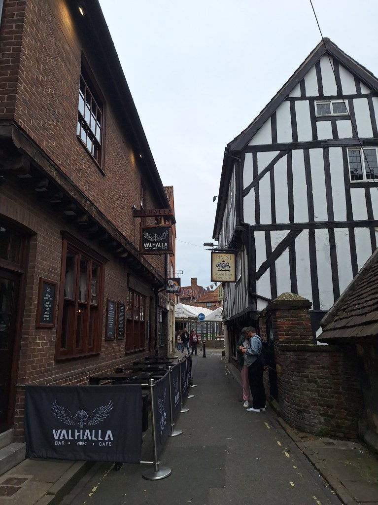 Exterior of two pubs with a narrow lane between them