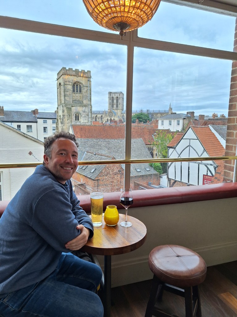 Person sat in the window of a bar with a city view visible