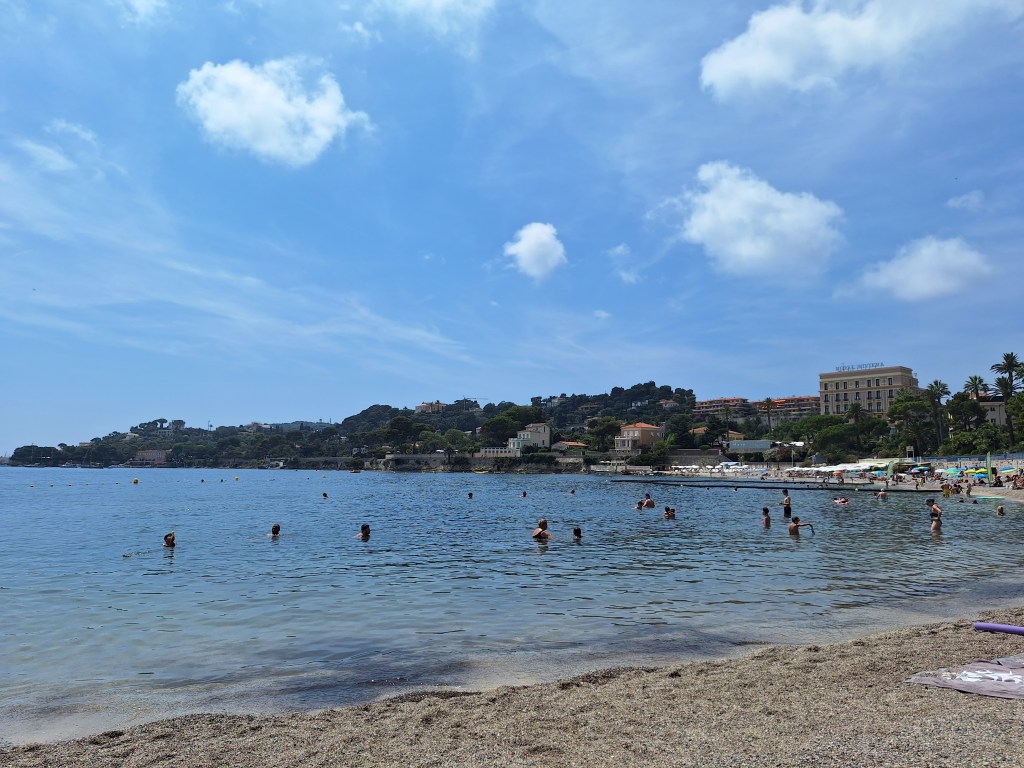 Beach with people swimming in the sea