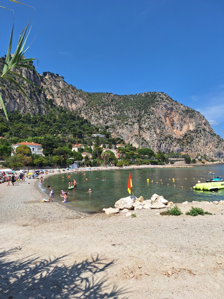 Small beach with mountains in background
