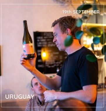 Man holding up wine bottle