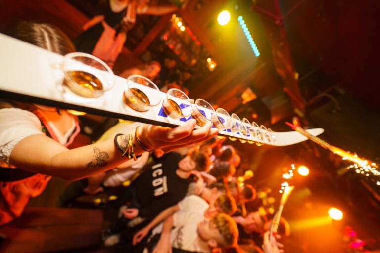 person holding tray of shots