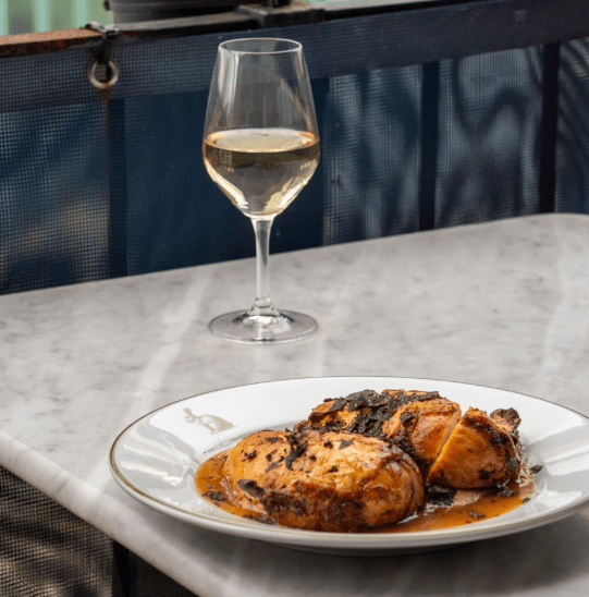 Chicken dish and glass of wine at Lapin in Bristol